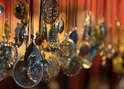 Close-up of decorations hanging in store for sale