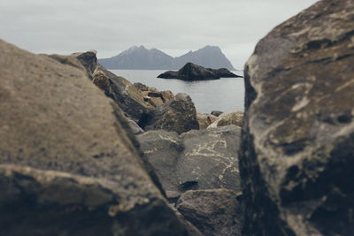 Rocks by sea against sky