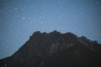 Scenic view of mountains against clear sky at night