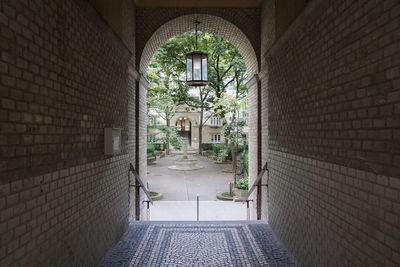 Corridor of building leading to a garden in vienna