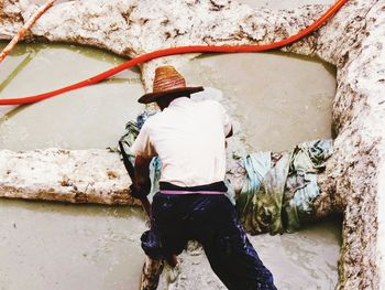 Rear view of man in river