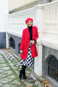 Portrait of young woman standing on steps