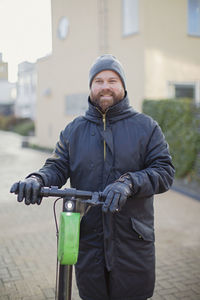 Man holding electric scooter