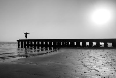 Pier over sea against clear sky