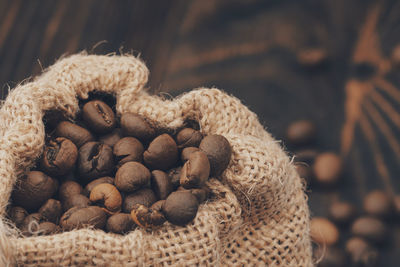 Burlap sack of roasted coffee beans. close up