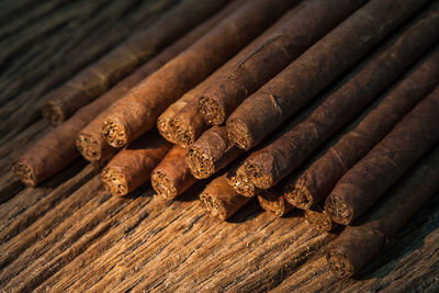 Close-up of cigars on wooden table