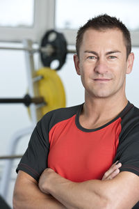 Mid adult man looking at camera in gym