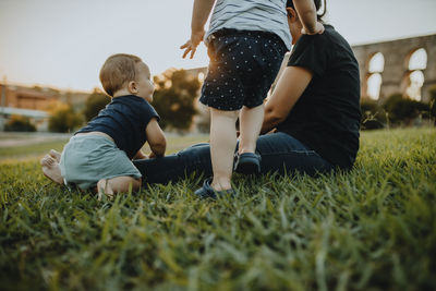 Mother with son and daughter on grass