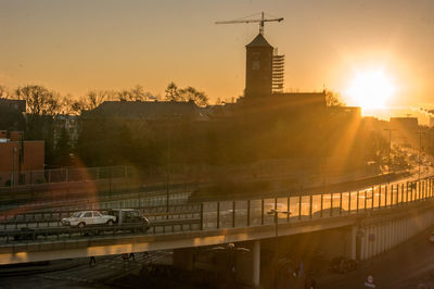 Buildings in city during sunset