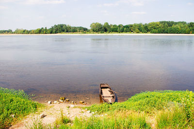 High angle view of abandoned boat in lake against sky