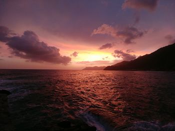 View of sea against cloudy sky during sunset