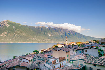 High angle view of townscape by sea against sky