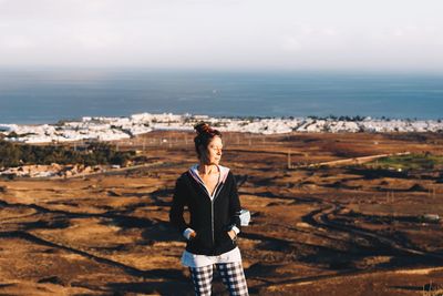 Full length of man standing on landscape against sea