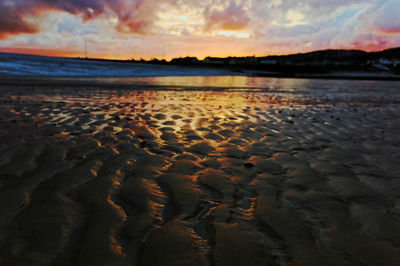 Scenic view of beach against sky during sunset