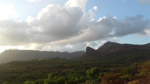 Scenic view of mountains against cloudy sky