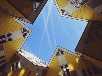 Low angle view of buildings against blue sky