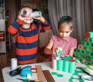 High angle view of father and son on table