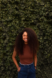 Portrait of smiling young woman standing outdoors