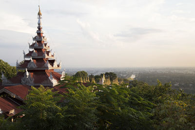 Red pagoda with mandalay's cityscape viewed from mandalay hill