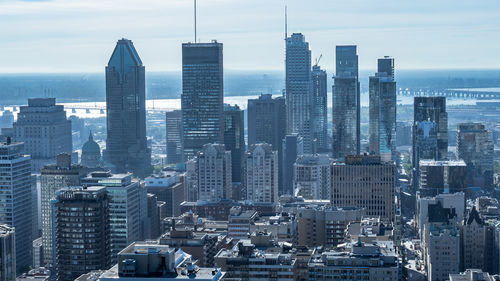 Aerial view of modern buildings in city against sky