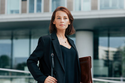 Young businesswoman standing in city