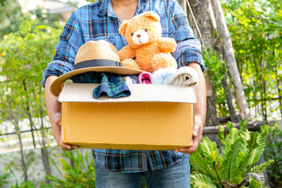 Rear view of woman holding teddy bear