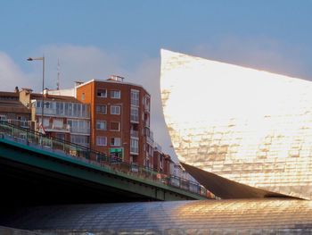 View of bridge in city against sky