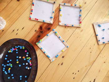 High angle view of multi colored pencils on hardwood floor