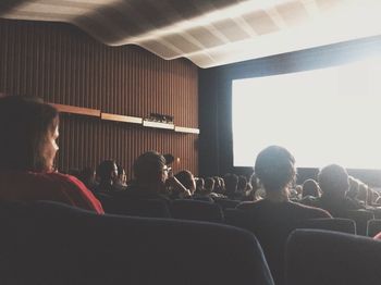 Rear view of people looking at camera