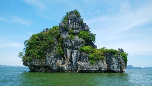 Scenic view of rock formation in sea against sky