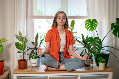 Young woman sitting at home