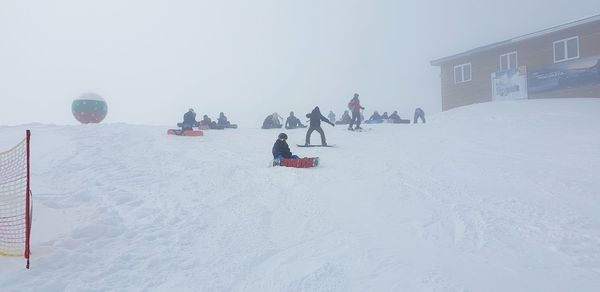 People on snow covered field