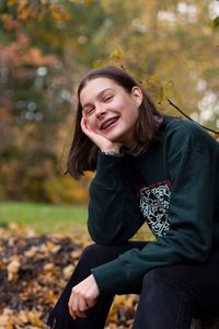 Portrait of a smiling young woman sitting outdoors