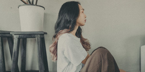 Side view of woman looking away at home