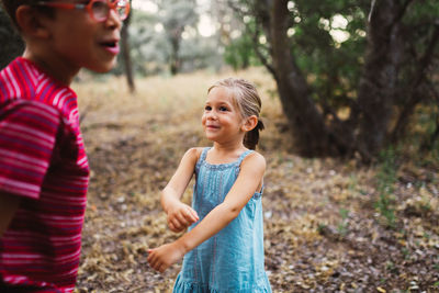 Siblings standing on land