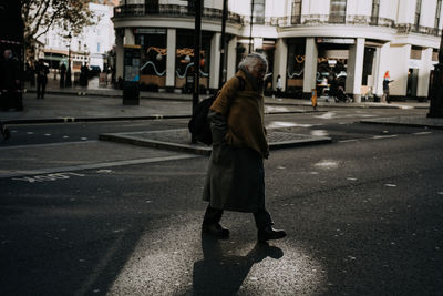 Rear view of woman walking on street