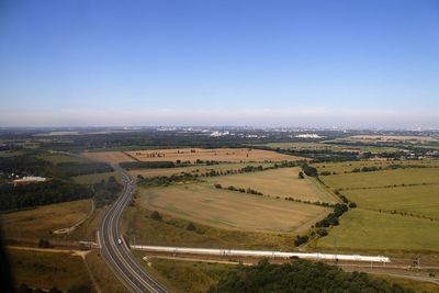 High angle view of field against cloudy sky