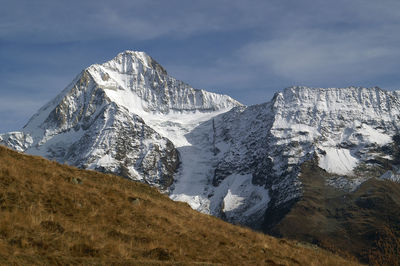 Scenic view of mountains against cloudy sky