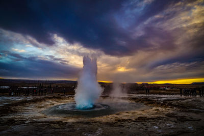 Fountain against sky during sunset