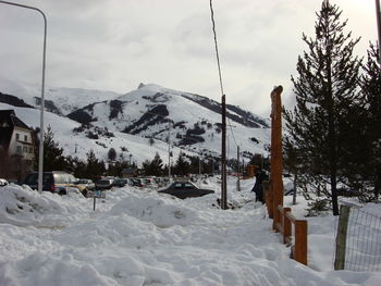 Snow covered landscape against sky