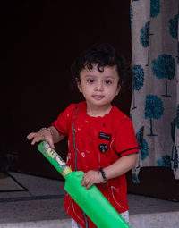 Portrait of cute girl playing with toy at home