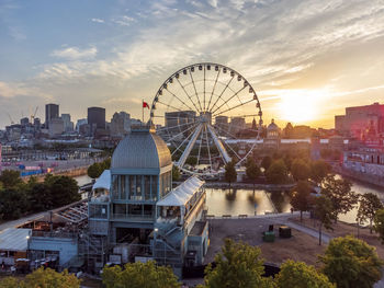 Ferris wheel in city at sunset