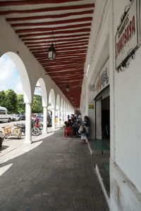 People on street amidst buildings in city