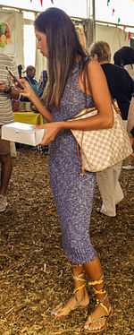 Close-up of woman holding umbrella standing on floor