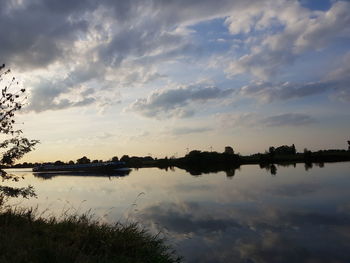 Scenic view of lake against sky at sunset