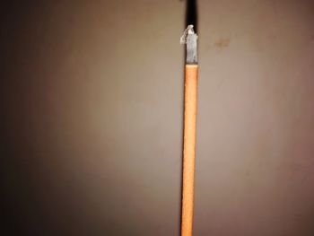 Close-up of pencils against wall