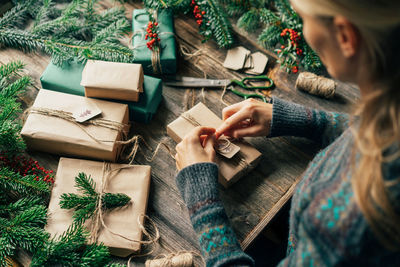 Woman wraps gifts for advent. christmas eve and crafting decorating. new year celebration.