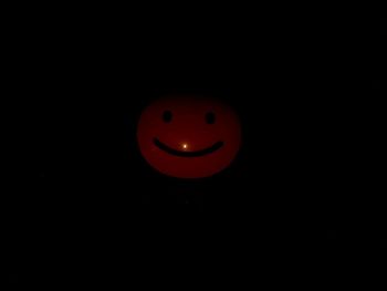 Close-up of red ball against black background