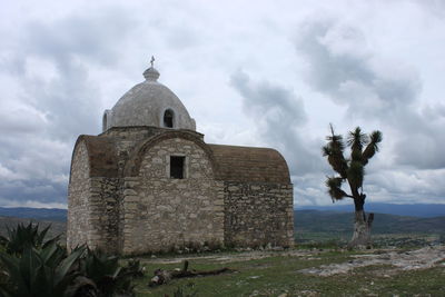Built structure against cloudy sky