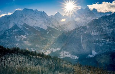 Scenic view of snowcapped mountains against bright sky